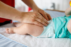 Close-up of father changing diaper of his newborn baby